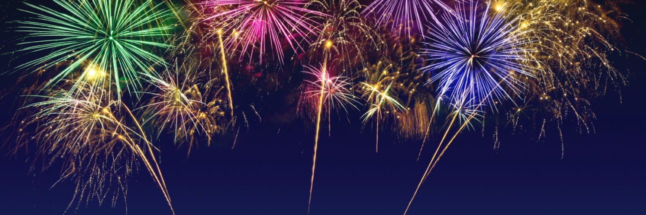 Colorful fireworks celebration on the twilight sky.